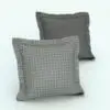 Square Revit Cushion Family With Flaps in 3D and rendered with a light gray textured material on the front and a darker gray material on the back. Ideal for modern and contemporary interior design projects, this fully-realistic Revit cushion family will transform your Revit projects in just a few clicks.